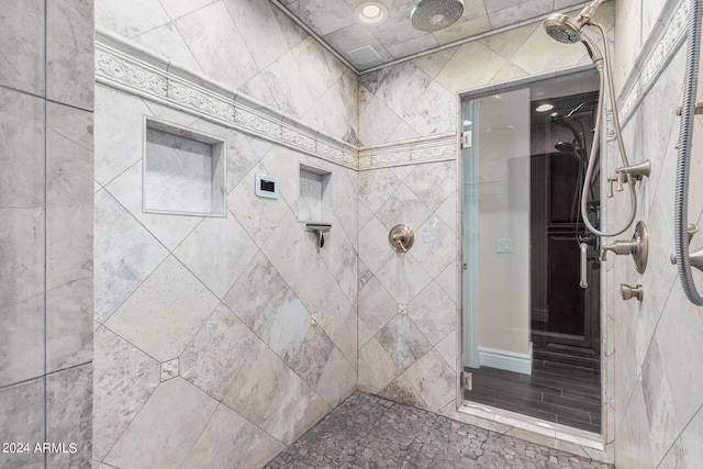 bathroom with a tile shower