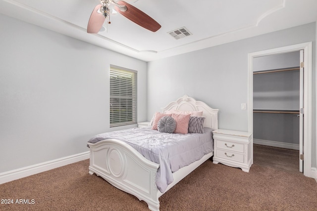 bedroom featuring ceiling fan and dark carpet