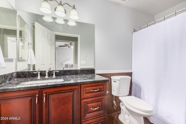 bathroom featuring ceiling fan, toilet, and vanity