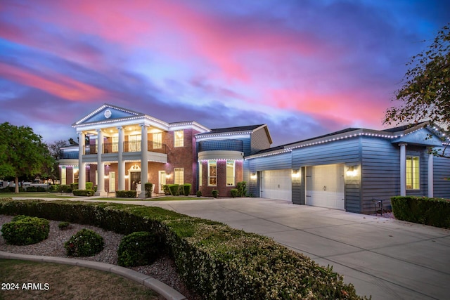 neoclassical home with a garage and a balcony