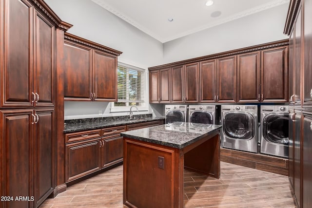 washroom with cabinets, light wood-type flooring, crown molding, sink, and independent washer and dryer