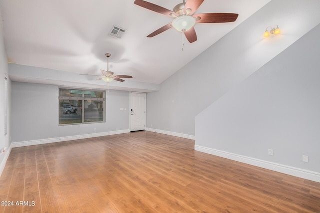 unfurnished living room with hardwood / wood-style flooring, ceiling fan, and vaulted ceiling