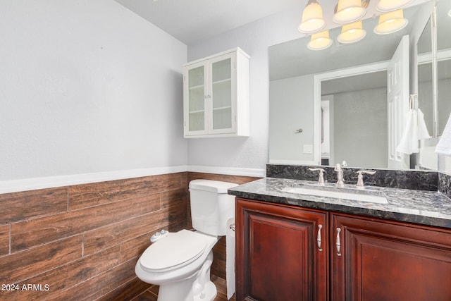 bathroom with hardwood / wood-style flooring, vanity, and toilet