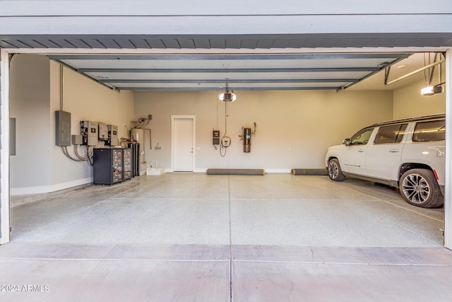 garage featuring electric panel, a garage door opener, and gas water heater