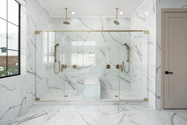 bathroom featuring stone wall, a marble finish shower, marble finish floor, and recessed lighting