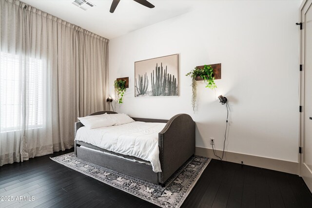 bedroom with a ceiling fan, baseboards, visible vents, and dark wood-type flooring