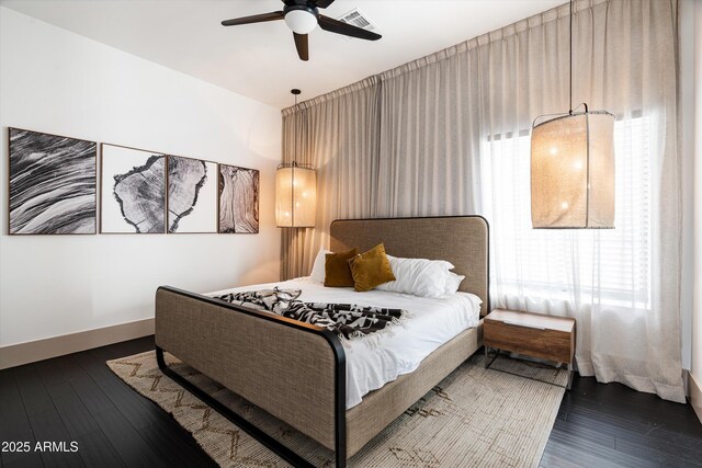 bedroom with baseboards, visible vents, ceiling fan, and wood finished floors