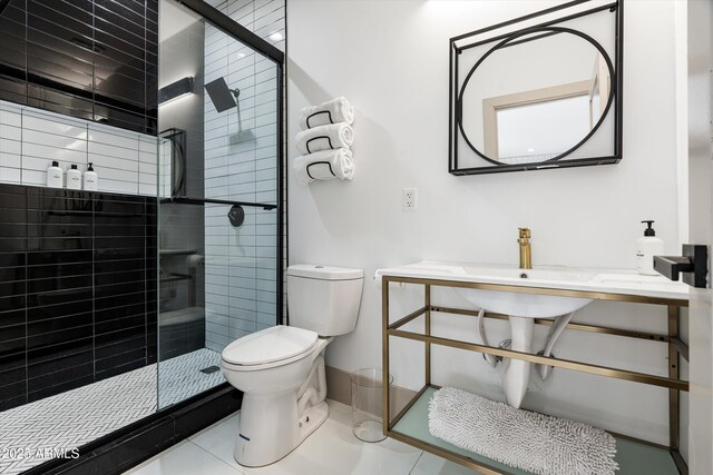 bathroom with toilet, a stall shower, and tile patterned floors