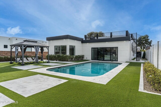 rear view of house with a fenced in pool, a patio, a lawn, a gazebo, and stairs