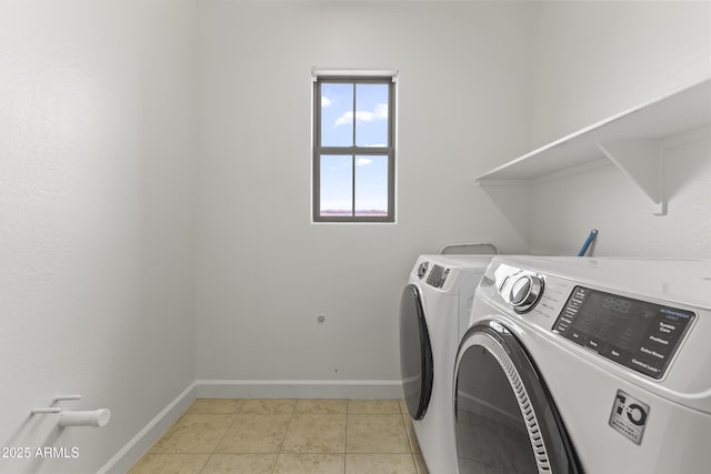 clothes washing area with baseboards, laundry area, light tile patterned flooring, and washer and dryer