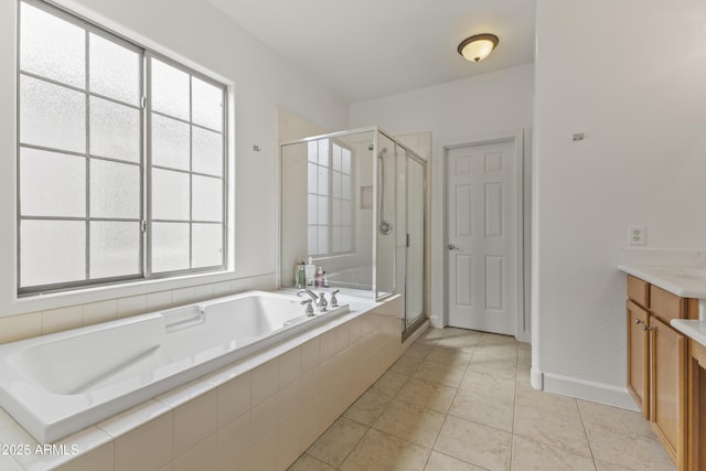 full bathroom with a stall shower, baseboards, tile patterned floors, vanity, and a bath