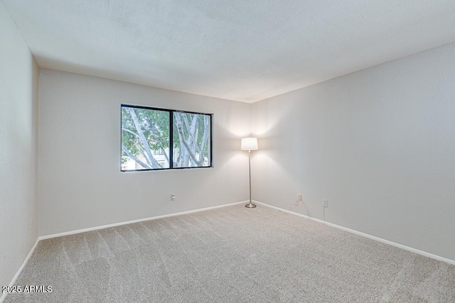 empty room with a textured ceiling and carpet