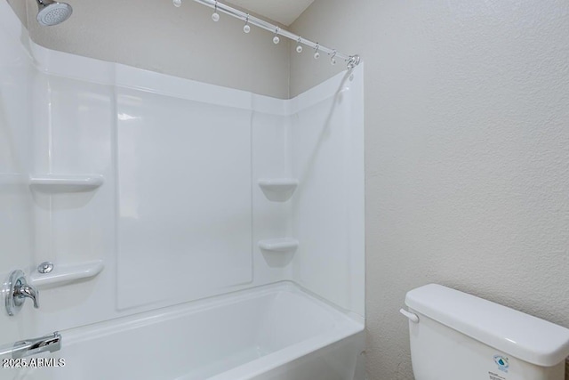 bathroom with shower / bathing tub combination and toilet