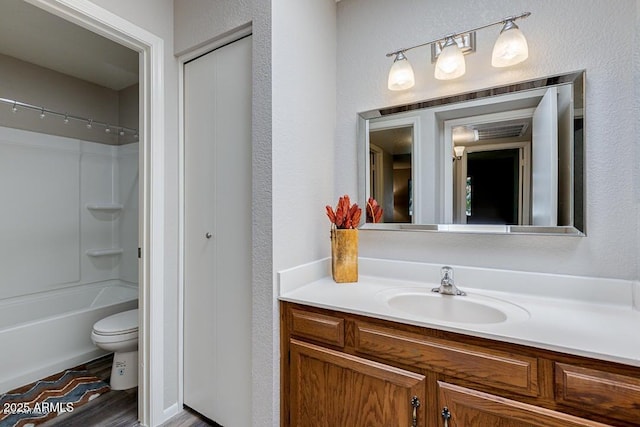 full bathroom with vanity, bathtub / shower combination, and toilet