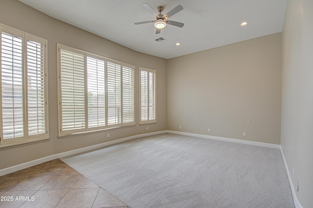 unfurnished room with recessed lighting, light colored carpet, a ceiling fan, baseboards, and visible vents