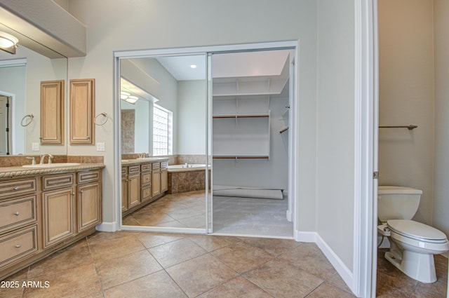 full bath featuring baseboards, toilet, a garden tub, tile patterned flooring, and vanity