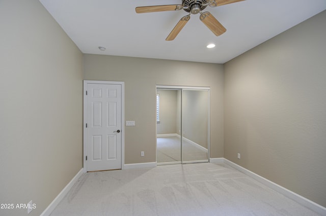 unfurnished bedroom featuring recessed lighting, a closet, a ceiling fan, carpet flooring, and baseboards