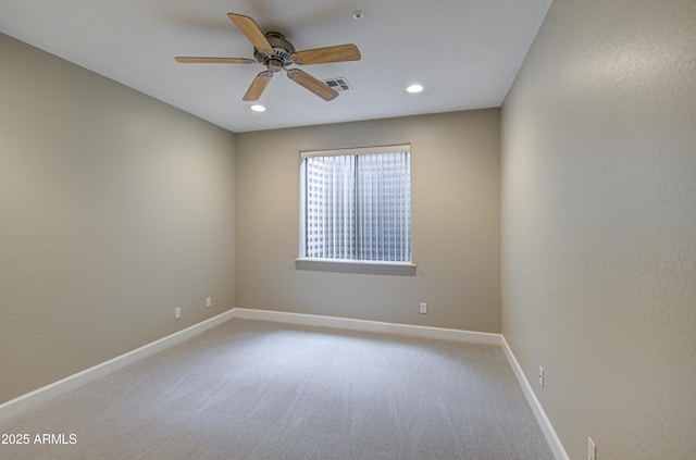 spare room featuring recessed lighting, light colored carpet, visible vents, a ceiling fan, and baseboards