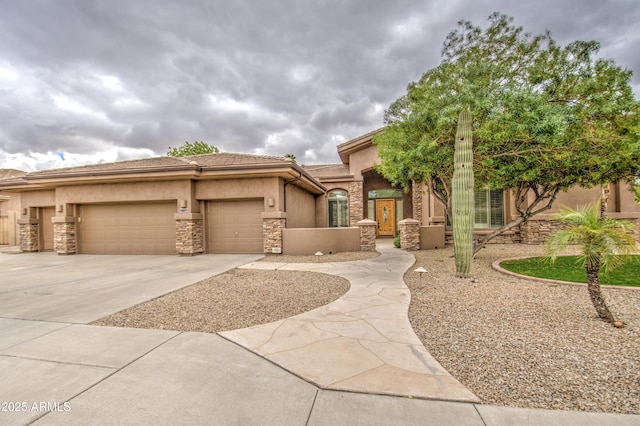 view of front facade with an attached garage, a tile roof, stone siding, concrete driveway, and stucco siding