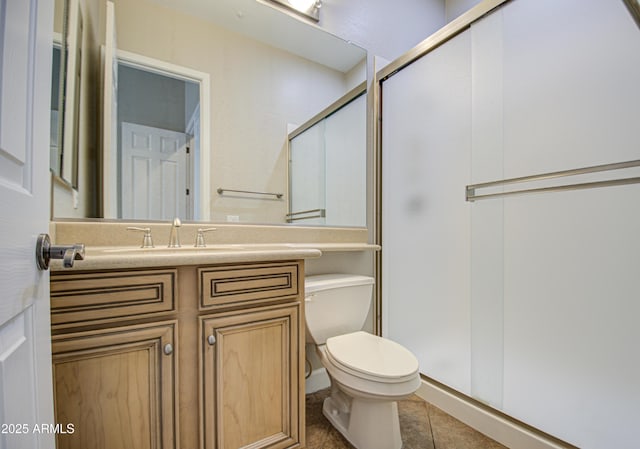 bathroom featuring vanity, tile patterned flooring, a shower stall, and toilet