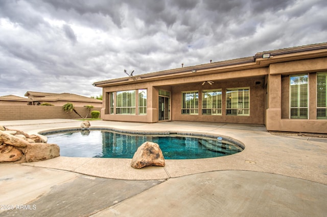 view of pool featuring a patio, fence, a fenced in pool, and a ceiling fan