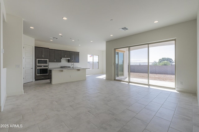 16367 W Desert Mirage Dr, Surprise, AZ 85388 - unfurnished living room with recessed lighting and visible vents