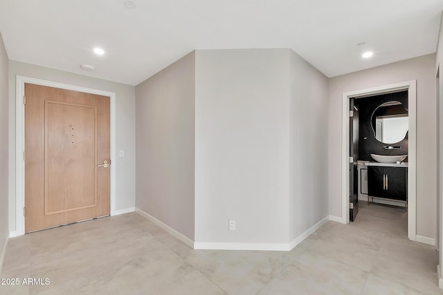 hall with recessed lighting and baseboards