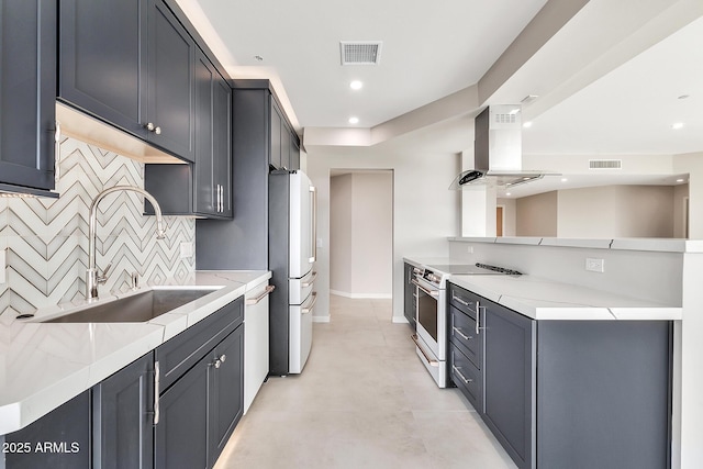 kitchen with white appliances, visible vents, island exhaust hood, and a sink