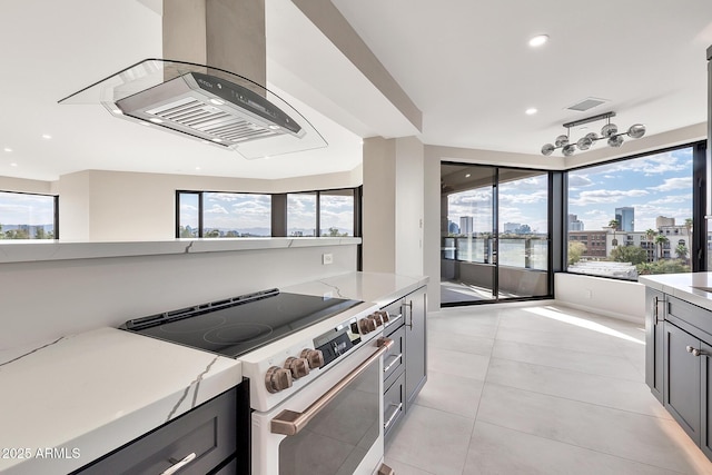 kitchen featuring a healthy amount of sunlight, visible vents, electric range oven, and exhaust hood