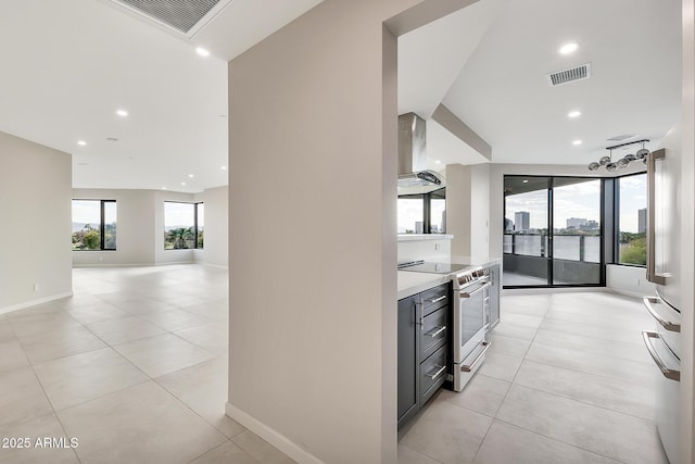 kitchen featuring extractor fan, visible vents, open floor plan, light countertops, and stainless steel electric range oven