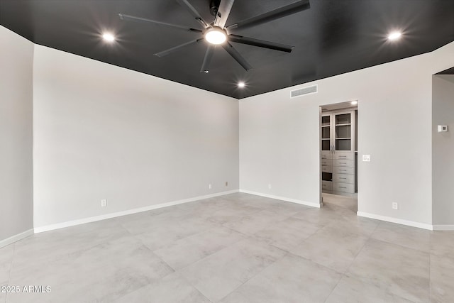 empty room with recessed lighting, visible vents, ceiling fan, and baseboards