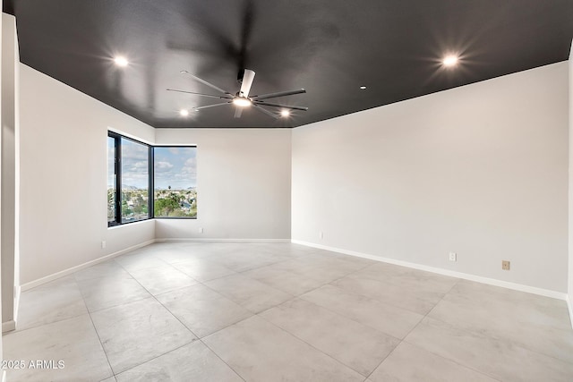 unfurnished room with baseboards, a ceiling fan, and recessed lighting