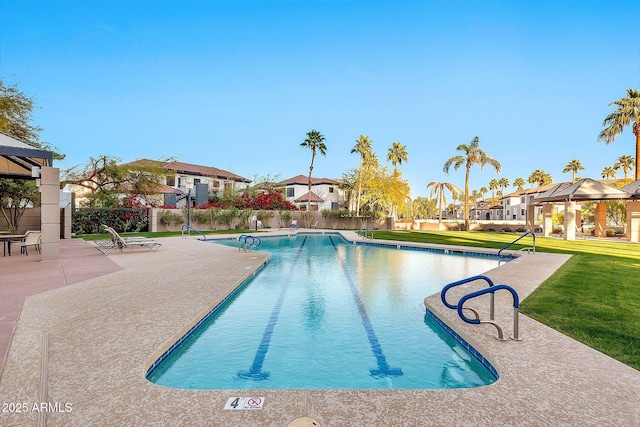 pool with a patio area, a residential view, a lawn, and a gazebo