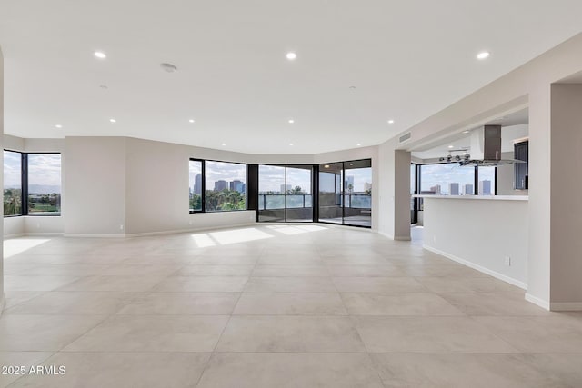 empty room with plenty of natural light, visible vents, baseboards, and recessed lighting