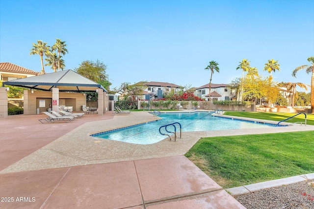 pool featuring a gazebo, a lawn, a patio area, and fence