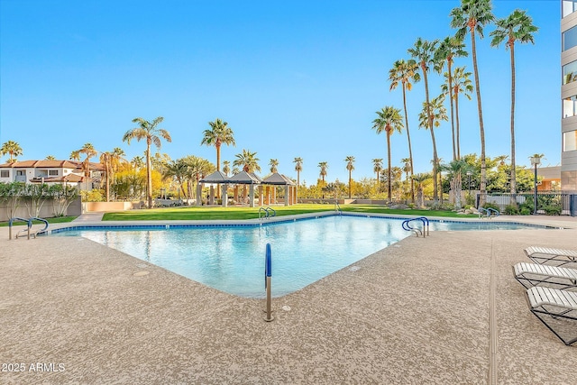 community pool with a yard, fence, a gazebo, and a patio