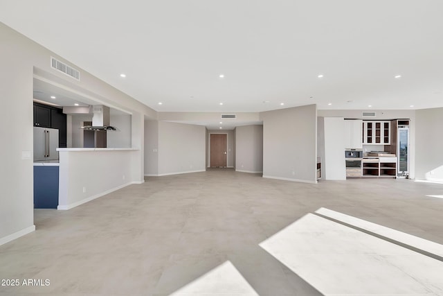 unfurnished living room with recessed lighting, visible vents, and baseboards