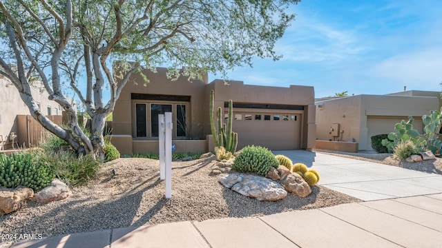 adobe home featuring a garage