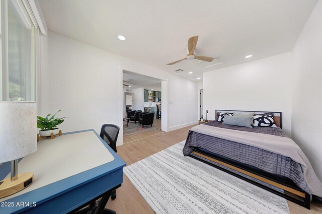 bedroom featuring visible vents, a ceiling fan, and light wood-style flooring