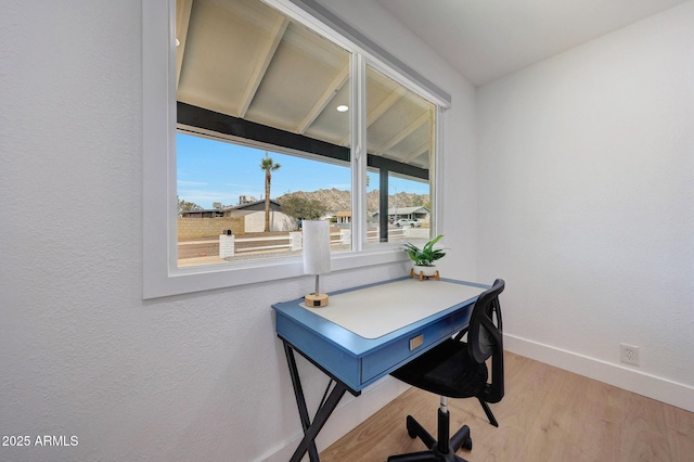 office space featuring light wood-style floors and baseboards