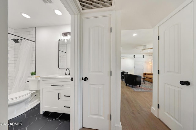 full bathroom featuring recessed lighting, a shower with curtain, toilet, vanity, and visible vents