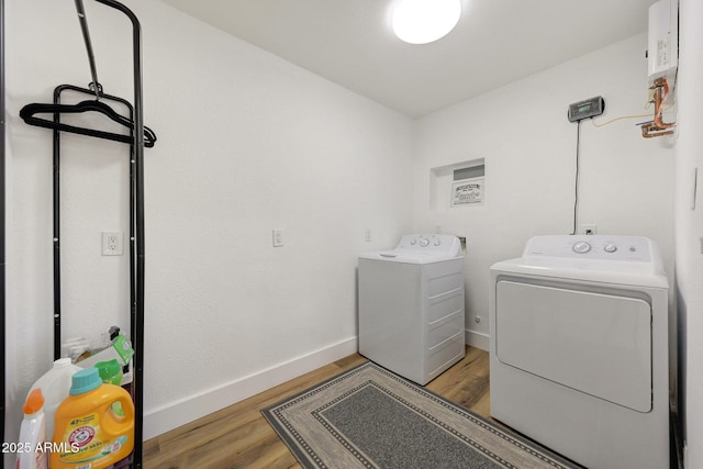 laundry room featuring baseboards, separate washer and dryer, laundry area, and light wood-style flooring