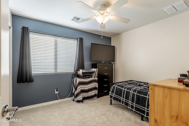 carpeted bedroom featuring visible vents, baseboards, and ceiling fan