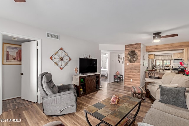 living room with hardwood / wood-style floors and ceiling fan