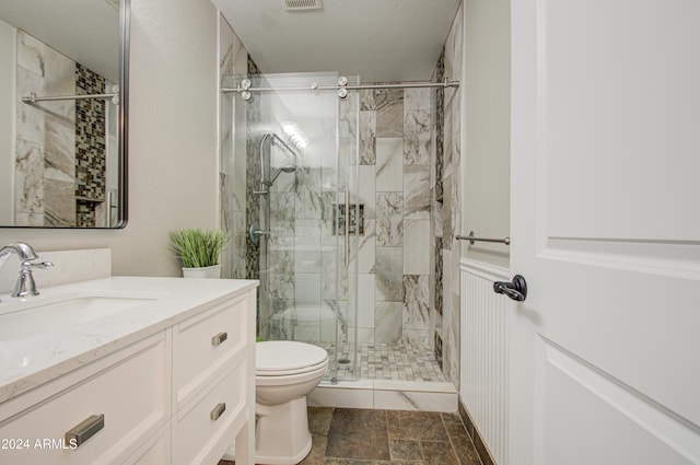 bathroom featuring vanity, toilet, and walk in shower