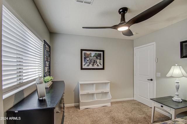 carpeted office with ceiling fan