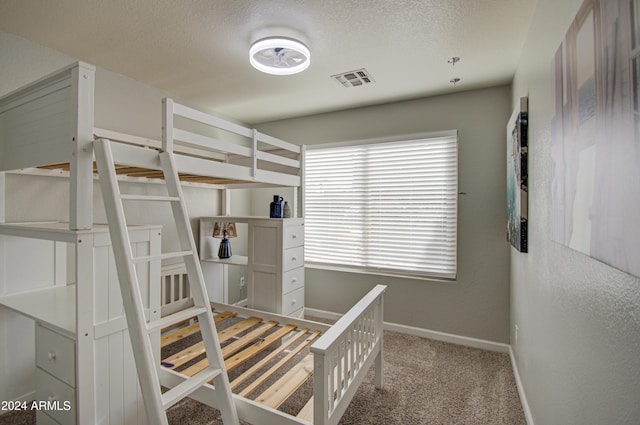 unfurnished bedroom with a textured ceiling and carpet floors