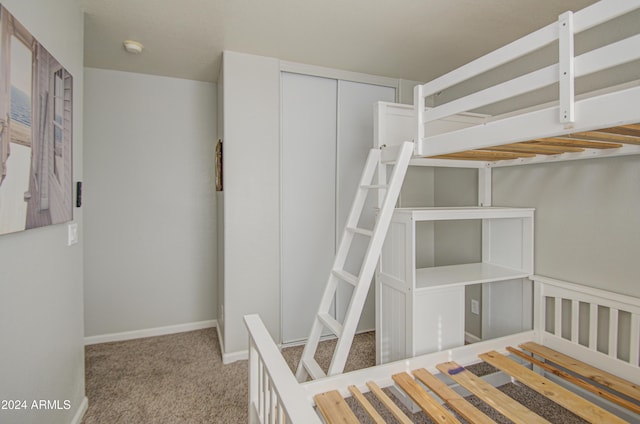 unfurnished bedroom with light carpet and a closet