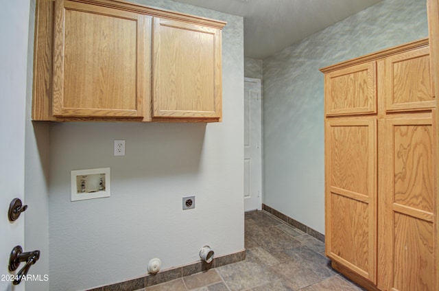 washroom featuring electric dryer hookup, hookup for a washing machine, and cabinets