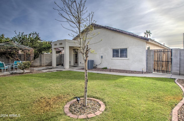 back of house featuring a gazebo, a patio area, and a lawn